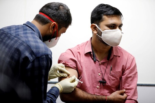 A medic administers an experimental COVID-19 vaccine to a health worker during trials in Ahmedabad. (REUTERS)