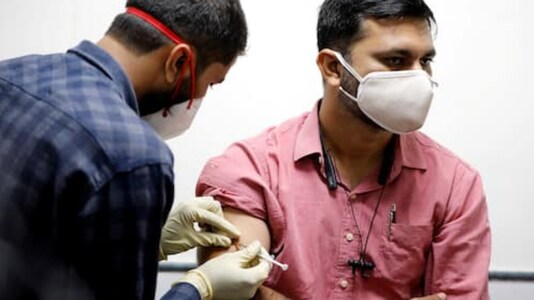 A medic administers an experimental COVID-19 vaccine to a health worker during trialsin Ahmedabad. (REUTERS)