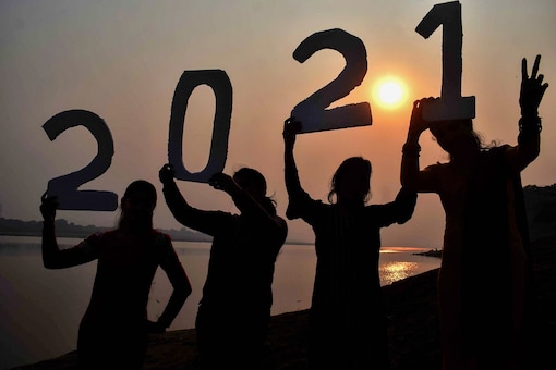  Young women pose to welcome the New Year 2021 at Sangam, in Prayagraj, Thursday. (PTI)