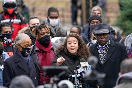 Kat Rodriguez, center, mother of Keyon Harrold Jr. speaks as attorney Ben Crump, right, Rev. Al Sharpton, left, and Keyon Harrold Sr. listen during a news conference Wednesday, Dec. 30, 2020, in New York. (AP Photo/Frank Franklin II)