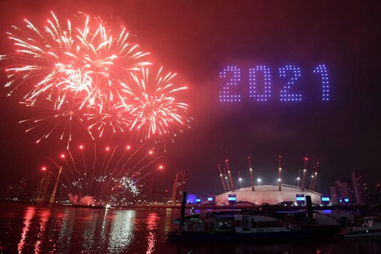 Fireworks and drones illuminate the night sky over London after the city’s normal New Year's Eve fireworks display was cancelled due to the coronavirus pandemic, on December 31, 2020. (Victoria Jones/PA via AP)