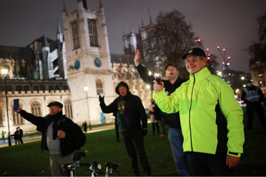 People gather to celebrate in Parliament Square, as Britain formally exits the EU, in London, Britain December 31, 2020. REUTERS/Hannah McKay People gather to celebrate in Parliament Square, as Britain formally exits the EU, in London, Britain December 31, 2020. REUTERS/Hannah McKay