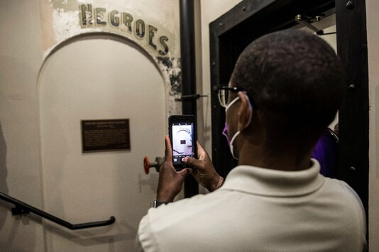 FILE - In this Monday, Nov. 17, 2020 file photo, Dannion McLendon takes a photo of the historical marker placed and sign that reads 