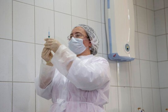 A Russian medical worker prepares a shot of Russia's experimental Sputnik V coronavirus vaccine for its use in Moscow, Russia.  (AP Photo/Alexander Zemlianichenko Jr, File)