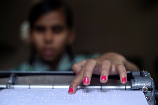 A visually impaired girl reads Braille that she typed using a Braille typewriter at a school for the visually impaired in Mumbai, India, January 2, 2019. REUTERS/Francis Mascarenhas     TPX IMAGES OF THE DAY - RC1905A48390