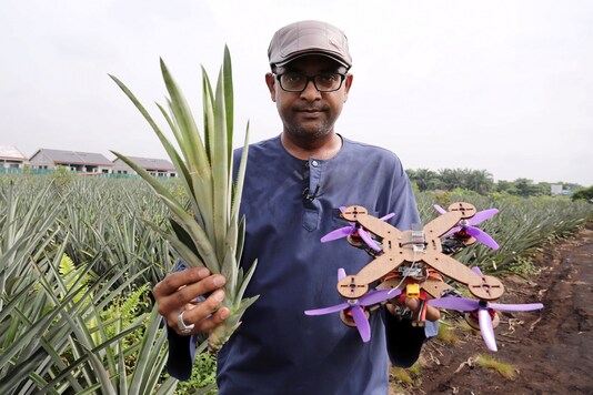 University Putra Malaysia professor Mohamed Thariq holds pineapple leaves and a drone partially made with pineapple stems, in Jenjarom, Malaysia.

 REUTERS/Lim Huey Teng