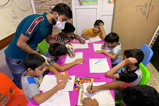 Iraqi orphan children draw in the classroom of an orphanage house during a curfew imposed to prevent the spread of the coronavirus disease (COVID-19), in Baghdad, Iraq. (Reuters) Iraqi orphan children draw in the classroom of an orphanage house during a curfew imposed to prevent the spread of the coronavirus disease (COVID-19), in Baghdad, Iraq. (Reuters)