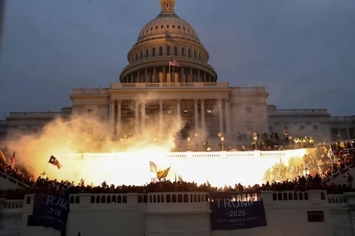 An explosion caused by a police munition is seen while supporters of US. President Donald Trump gather in front of the US Capitol Building in Washington. (Reuters)