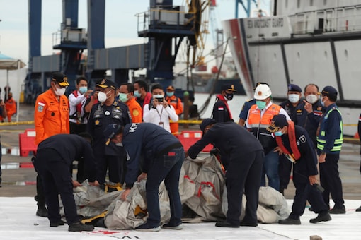 Rescuers inspect wreckage found in the waters around the location where a Sriwijaya Air passenger jet lost contact with air traffic controllers shortly after takeoff 