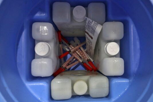 Syringes and ice packs are seen inside a vaccination box in Mumbai.