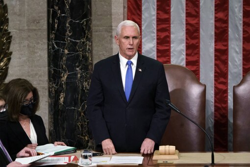 Vice President Mike Pence listens after reading the final certification of Electoral College votes cast in November's presidential election during a joint session of Congress after working through the night, at the Capitol in Washington, on January 7, 2021. (AP Photo/J. Scott Applewhite, Pool)