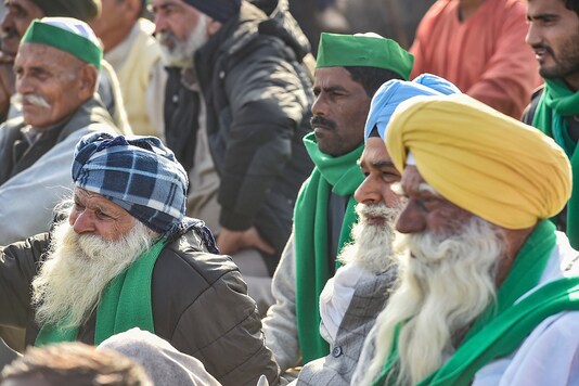 Farmers during their ongoing agitation against new farm laws, at Ghazipur border, in New Delhi, Monday. (PTI)