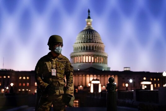 For File: Members of the National Guard gather at the U.S. Capitol as the House of Representatives prepares to begin the voting process on a resolution demanding U.S. Vice President Pence and the cabinet remove President Trump from office, in Washington, U.S., January 12, 2021. REUTERS/Erin Scott 