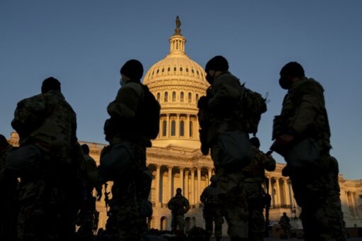 For Representation. Members of the National Guard gather outside the US Capitol on Wednesday ahead of the move to impeach Donald Trump. (AFP)