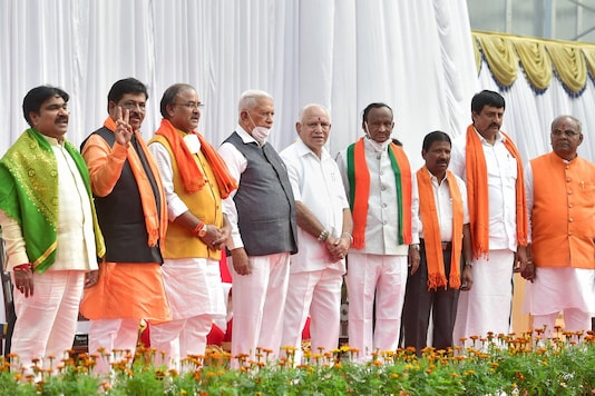 Karnataka Governor Vajubhai Vala along with Karnataka Chief Minister BS Yediyurappa and newly inducted ministers during the oath-taking ceremony, at Raj Bhavan in Bengaluru, Wednesday, January 13, 2021. (Image: PTI)
