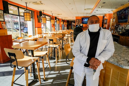 Andrew Walcott, owners of Fusion East Caribbean & Soul Food restaurant, poses for a photo at the restaurant in East New York neighborhood of the Brooklyn borough of New York, Thursday, Jan. 7, 2021. Walcott had to furlough four employees at his restaurant just before Christmas, after New York state stopped allowing indoor dining. (AP Photo/Mary Altaffer) Andrew Walcott, owners of Fusion East Caribbean & Soul Food restaurant, poses for a photo at the restaurant in East New York neighborhood of the Brooklyn borough of New York, Thursday, Jan. 7, 2021. Walcott had to furlough four employees at his restaurant just before Christmas, after New York state stopped allowing indoor dining. (AP Photo/Mary Altaffer)