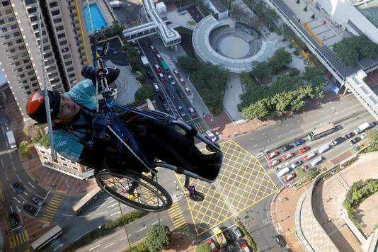 Lai Chi-wai, a paraplegic climber, attempts to climb the 320-metre tall Nina Tower using only his upper body strength, in Hong Kong, China.

REUTERS/Tyrone Siu
