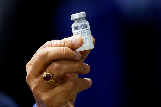 Indian Health Minister Harsh Vardhan holds a vial of Covaxin. (Reuters)