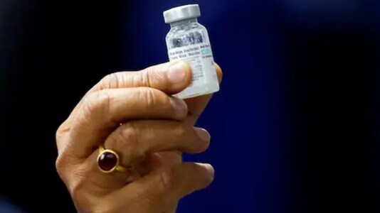 Indian Health Minister Harsh Vardhan holds a dose of Bharat Biotech's COVID-19 vaccine called COVAXIN. (Reuters)