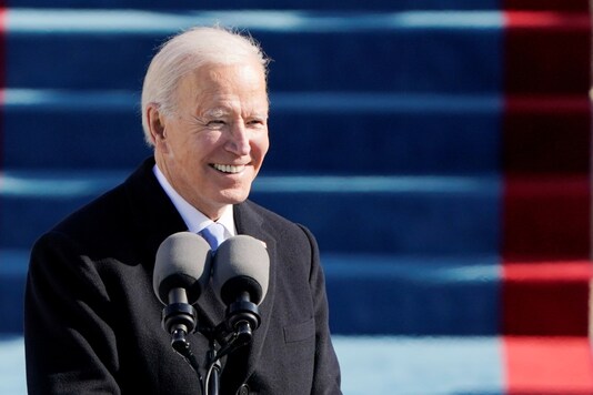 Joe Biden smiles as he addresses the crowd at the inauguration ceremony on Saturday. (Reuters)