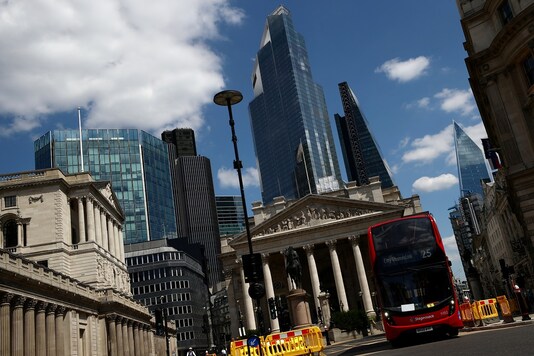 FILE PHOTO: A bus drives on an almost empty street, following the outbreak of the coronavirus disease (COVID-19), in the financial district of London.  REUTERS/Hannah McKay/File Photo