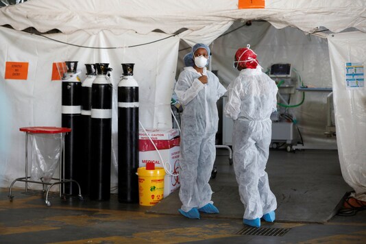 Healthcare workers chat at a temporary ward set up during the coronavirus disease (COVID-19) outbreak, at Steve Biko Academic Hospital in Pretoria, South Africa, January 19, 2021. Phill Magakoe/Pool via REUTERS