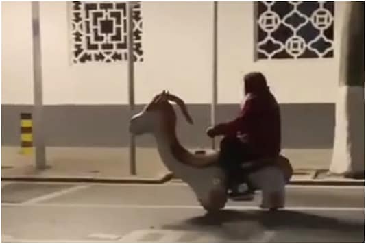 Old woman riding a toy scooter to work | Image credit: Twitter Old woman riding a toy scooter to work | Image credit: Twitter