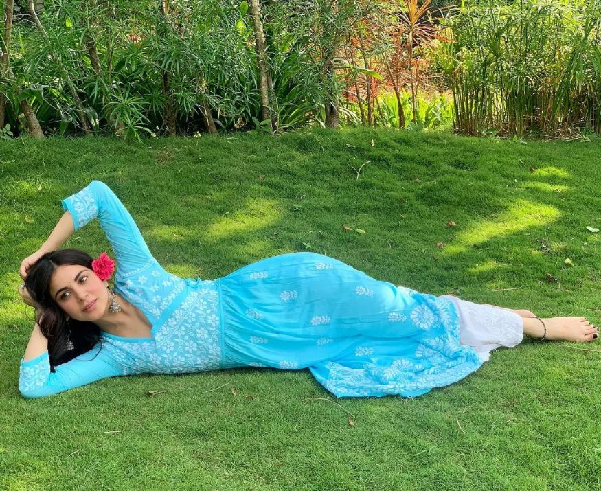 Lazing around in a park in blue kurta and white flared pants. (Image: Instagram)