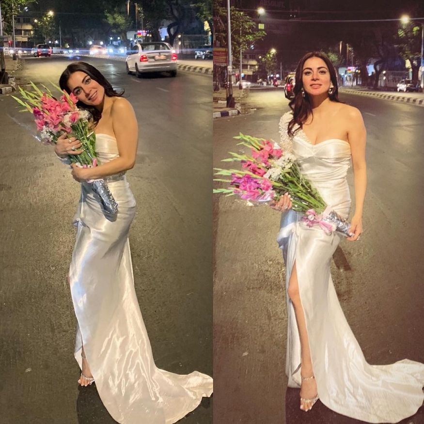 Posing on the streets in a white floor-length satin dress. (Image: Instagram)
