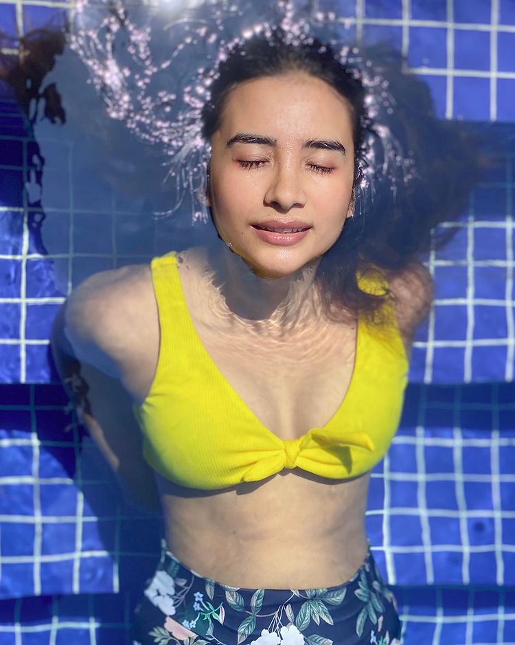  Enjoying a dip in the pool in a yellow bikini top. (Image: Instagram)