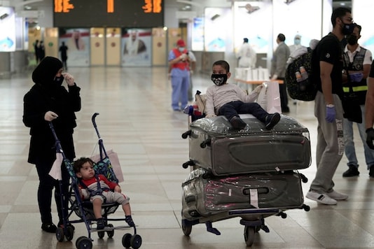 A Kuwaiti family repatriated from Amman, wearing protective face masks, prepare their luggage while arriving at Kuwait Airport, following the outbreak of the coronavirus disease (COVID-19), in Kuwait City, Kuwait April 21, 2020. REUTERS/Stephanie McGehee/Files A Kuwaiti family repatriated from Amman, wearing protective face masks, prepare their luggage while arriving at Kuwait Airport, following the outbreak of the coronavirus disease (COVID-19), in Kuwait City, Kuwait April 21, 2020. REUTERS/Stephanie McGehee/Files