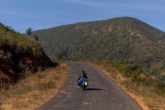 Reena Jani, 34, a health worker, rides on her neighbour's motorcycle as she travels to Mathalput Community Health Centre to receive the vaccine developed by Oxford/AstraZeneca, during the coronavirus disease (COVID-19) pandemic, in Koraput, India, January 16, 2021. 