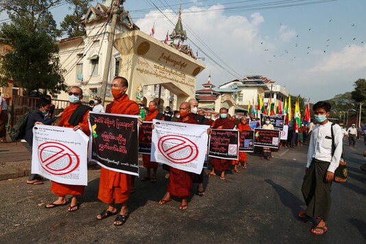 Buddhist monks hold placards as they participate in a rally protesting election results by supporters of the Myanmar military and the military-backed Union Solidarity and Development Party near Shwedagon pagoda Saturday, Jan. 30, 2021, in Yangon, Myanmar. Myanmar’s military has denied that controversial statements by its chief were meant as a threat to stage a coup, claiming the media had misinterpreted his words. Political tension soared this past week after the military said it could not rule out a coup if its complaints of widespread voting fraud in last November’s election were ignored. (AP Photo/Thein Zaw)