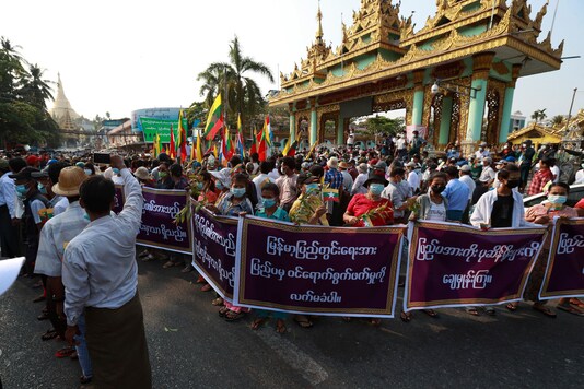 (Only for representation)Supporters of the Myanmar military and the military-backed Union Solidarity and Development Party hold placards that read 