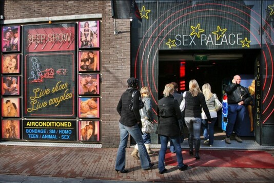 Visitors enter a peep-show theatre during the first-ever open day of Amsterdam's red light district February 18, 2006. REUTERS/Paul Vreeker/File Photo


