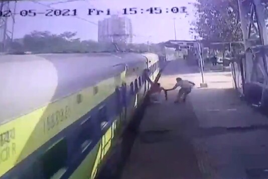 Railway personnel saving a disabled man who lost balance while trying to board a moving Mumbai local.