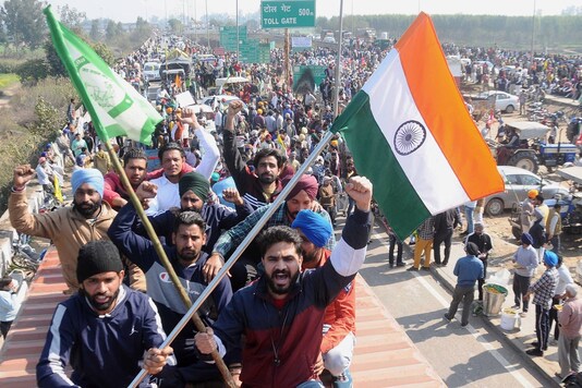 Farmers block Shambhu Highway during their 'chakka jam' protest as part of the ongoing agitation over new farm laws, in Patiala, Saturday, Feb. 6, 2021. (PT Photo)