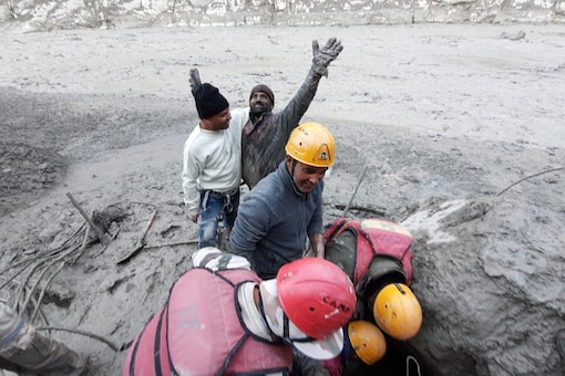 A rescued worker, who was trapped in a flooded tunnel near Tapovan Dam, rejoices as rescue personnel pull him out of the debris. At least 16 workers were rescued by an ITBP team. 