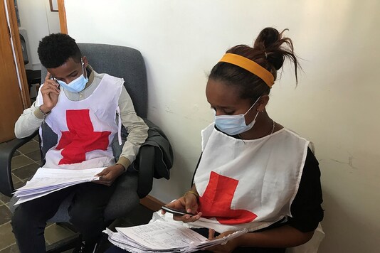 Workers from the International Committee of the Red Cross (ICRC) check data before distributing relief supplies to civilians in Tigray region, Ethiopia January 4, 2021. (Credit: International Committee of the Red Cross/Handout via REUTERS)