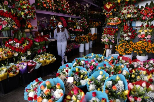 Florist Maria Alvarez, 25, waits for customers in her store, as the coronavirus disease (COVID-19) outbreak continues, ahead of Valentine's Day in Los Angeles. (Credit: REUTERS/Lucy Nicholson)