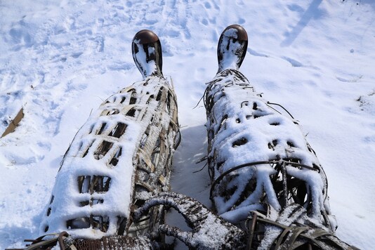 Snow covered boots on the Wicker Man sculpture are seen, following snowfall at Low Burnhall Woods, in Durham, Britain, February 10, 2021. (REUTERS/Lee Smith)