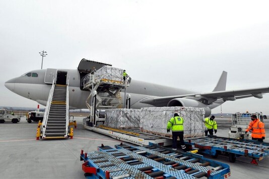 Boxes containing vaccines are unloaded from a Hungarian Airbus 330 cargo plane as the first batch of the vaccine against the new coronavirus produced by Sinopharm of China arrives at Budapest Liszt Ferenc International Airport in Budapest, Hungary, Tuesday, Feb. 16, 2021. The vaccine will not be used without its examination and approval by the National Public Health Center of Hungary. (Zoltan Mathe/MTI via AP)