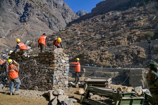 BRO workers work for construction of a bridge connecting Mallari with Raini village, in flood hit Chamoli district of Uttarakhand. (PTI Photo)