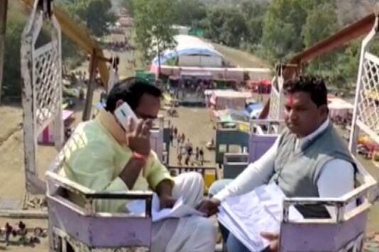 MP minister Brajendra Singh Yadav atop a 50 foot high swing. (Image: Twitter/PTI/@TheVijayKedia)