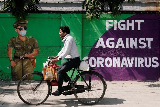 A man cycles past a graffiti in Mumbai. (Reuters)