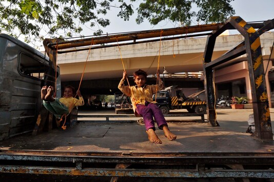 Children play on improvised swings on a tow truck parked on a roadside. (Image for representation/REUTERS)