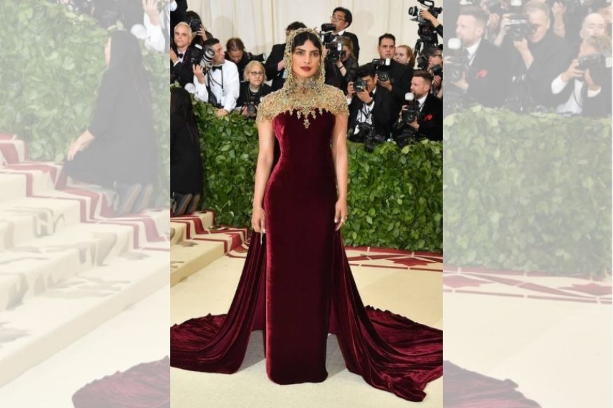  In 2018, Priyanka Chopra turned heads on the red carpet of the Catholic-inspired Met Gala. She opted for a Ralph Lauren creation this year — strapless velvet crimson gown paired with an embellished gold chain covering her head and neck. The actor was in synch with the Met Gala theme of ‘Heavenly Bodies: Fashion and the Catholic Imagination’. She completed the look with a deep red shade on her lips. But that didn't stop netizens from churning out hilarious memes about her outfit. Photo: Instagram/Priyanka Chopra