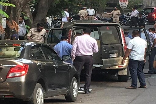 A team of investigators examining the vehicle.