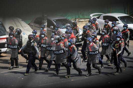 Riot police officers advance on pro-democracy protesters during a rally against the military coup in Yangon, Myanmar, February 27, 2021. (REUTERS)