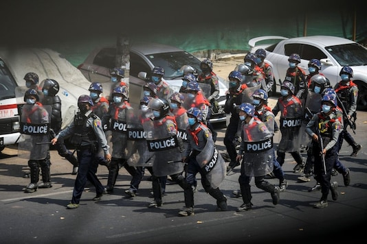 Riot police officers advance on pro-democracy protesters during a rally against the military coup in Yangon, Myanmar, February 27, 2021. (REUTERS)